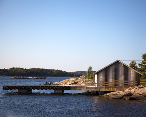 snøhetta reconstructs boat house on the shores of norwegian island