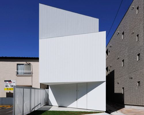 akio takatsuka fortifies suburban house behind angled white walls