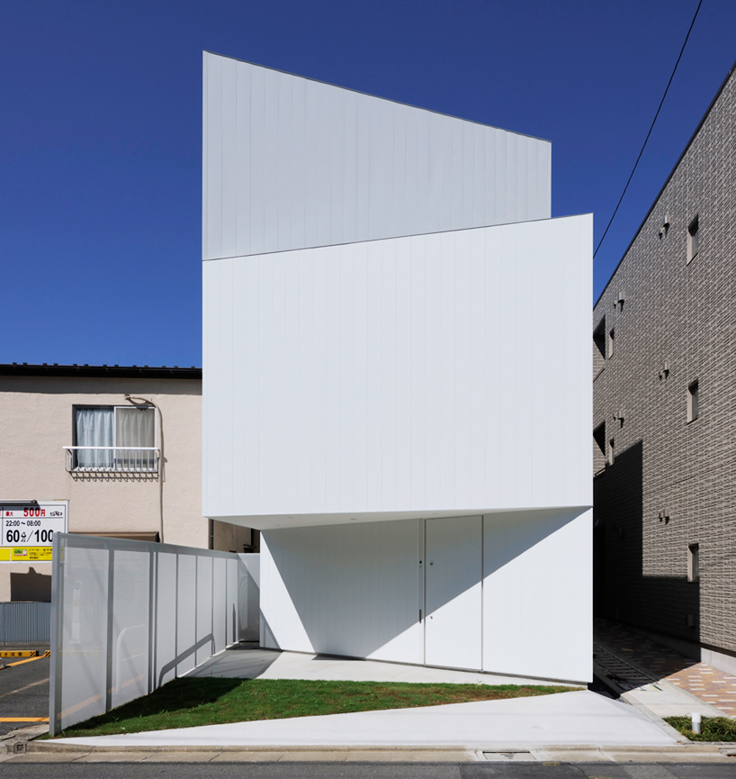 akio takatsuka fortifies suburban house behind angled white walls