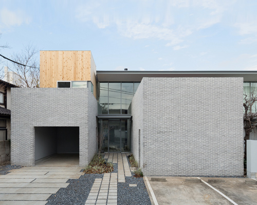 comma design office arranges tokyo dwelling around grey-brick wall