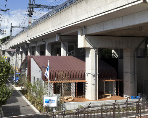 framedesign co places tokyo outdoor fitness club under elevated railway
