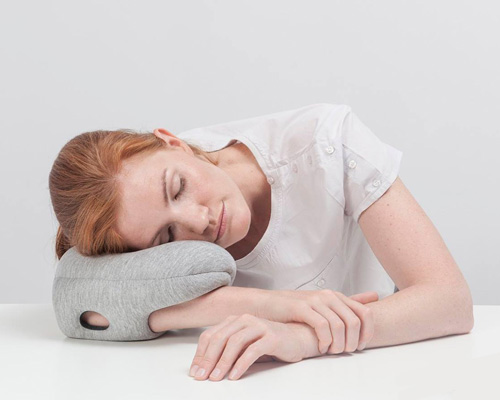 ostrich pillow mini attaches to hand, arm + elbow for easy napping