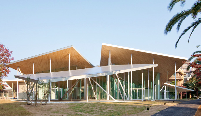 SANAA places junko fukutake hall beneath angled steel roof canopies