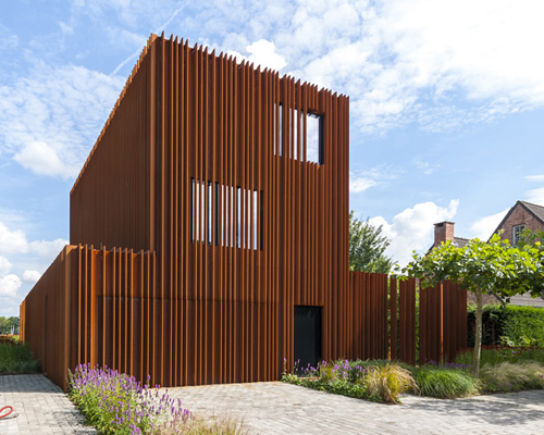 DMOA architecten forges corten house from weathering steel lamellae