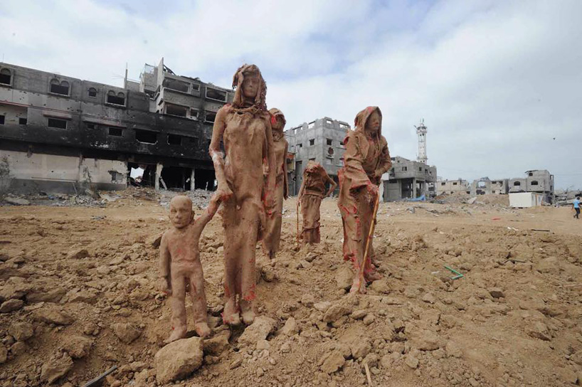 palestinian artist sculpts clay family fleeing from homes in gaza