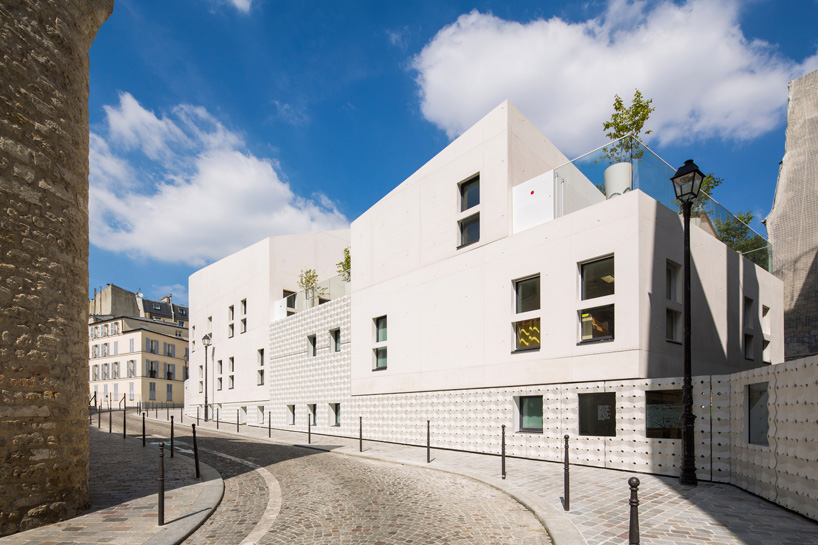 rh+ architecture shapes white concrete for childcare center in paris