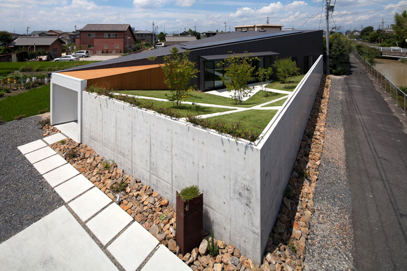 bandesign hides secret garden behind concrete façades