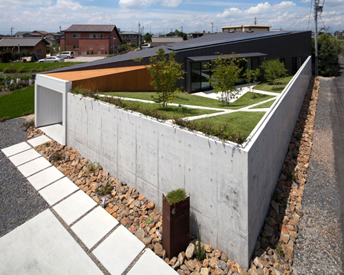 bandesign hides secret garden behind concrete façades