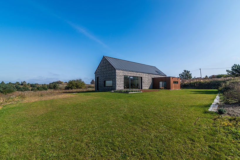 kropka studio projects a house in the landscape of stone and wood
