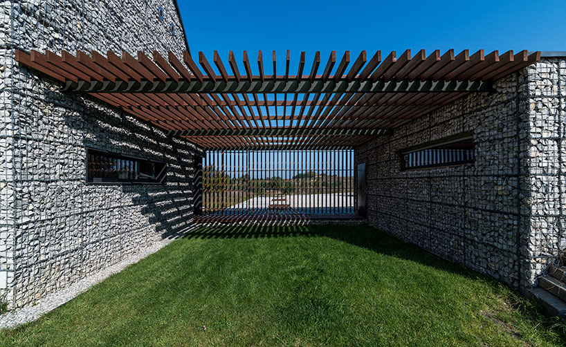 kropka studio projects a house in the landscape of stone and wood