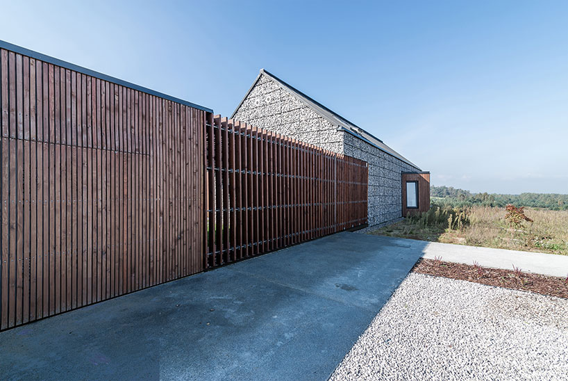 kropka studio projects a house in the landscape of stone and wood