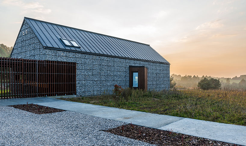 kropka studio projects a house in the landscape of stone and wood