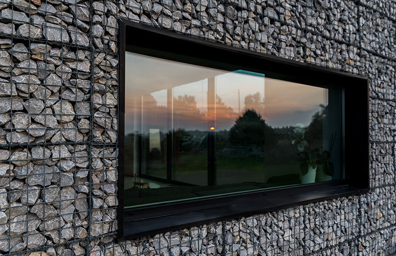 kropka studio projects a house in the landscape of stone and wood