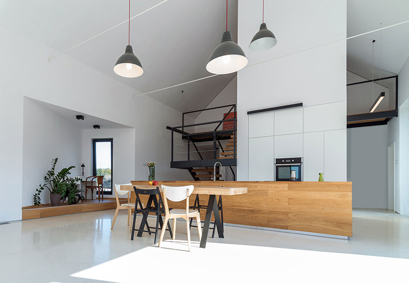 kropka studio projects a house in the landscape of stone and wood