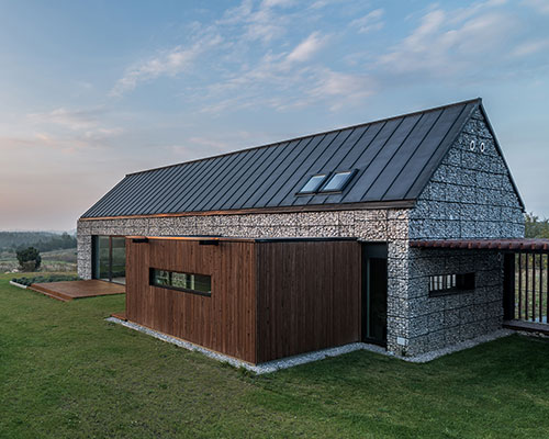 kropka studio projects a house in the landscape of stone and wood 