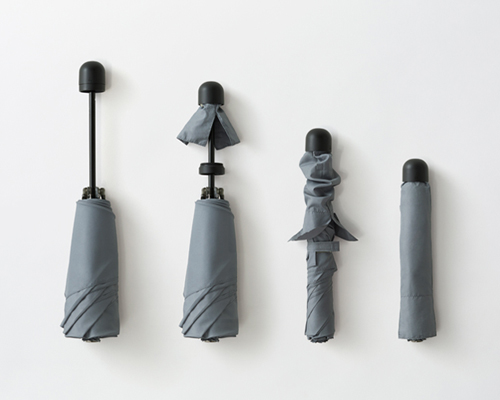 nendo's coverbrella for by | n hides protective shield inside handle