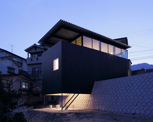 yoshio ohno's timber house in miyake straddles a four meter retaining wall