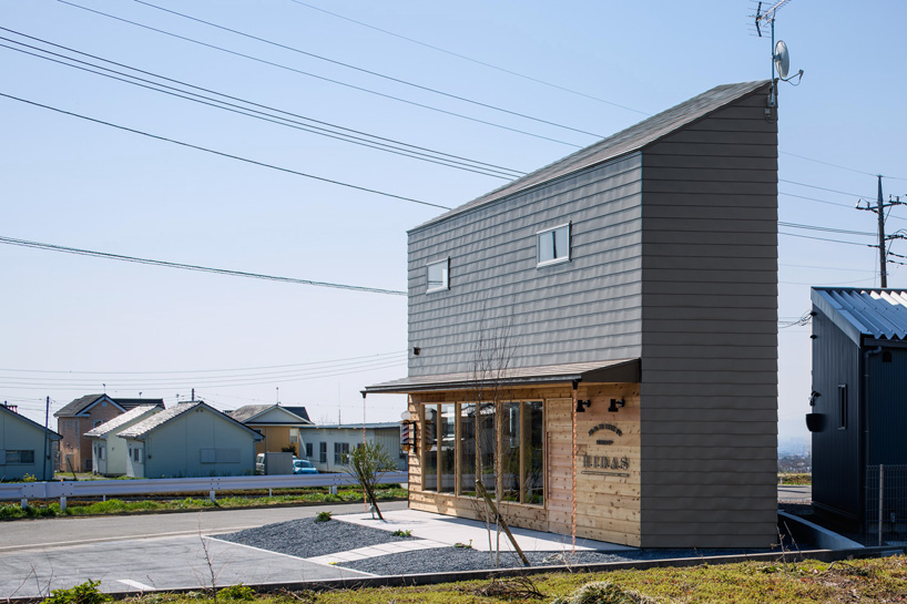 SNARK + OUVI's timber dwelling houses a barber shop at ground level