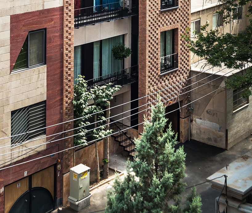 boozhgan architecture studio sculpts a dynamic brick facade for the haghighi house