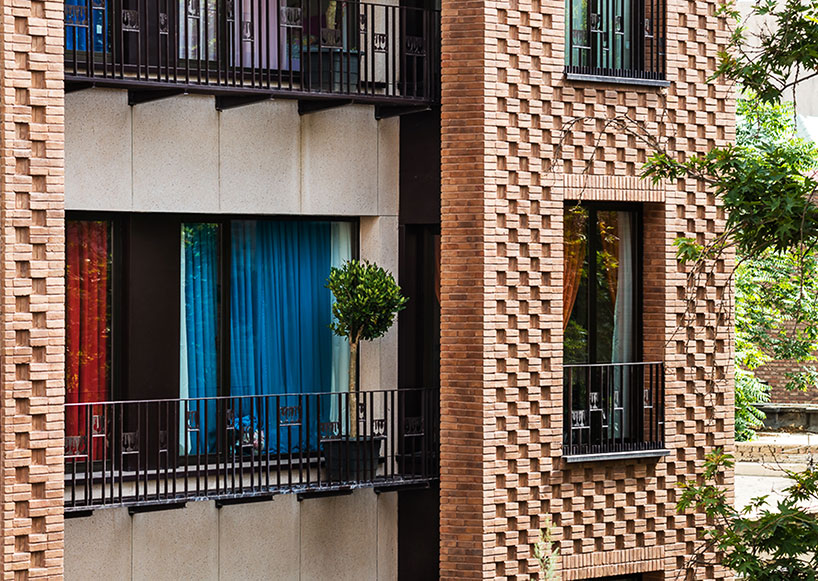 boozhgan architecture studio sculpts a dynamic brick facade for the haghighi house