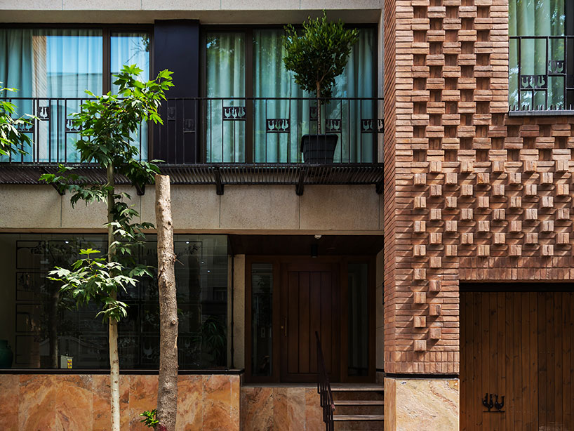 boozhgan architecture studio sculpts a dynamic brick facade for the haghighi house