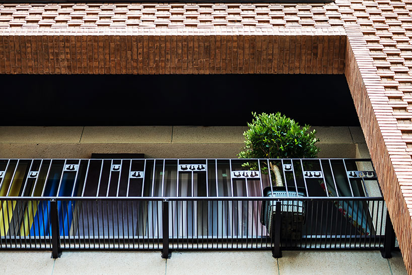 boozhgan architecture studio sculpts a dynamic brick facade for the haghighi house