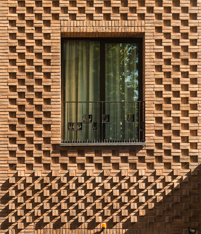 boozhgan architecture studio sculpts a dynamic brick facade for the haghighi house