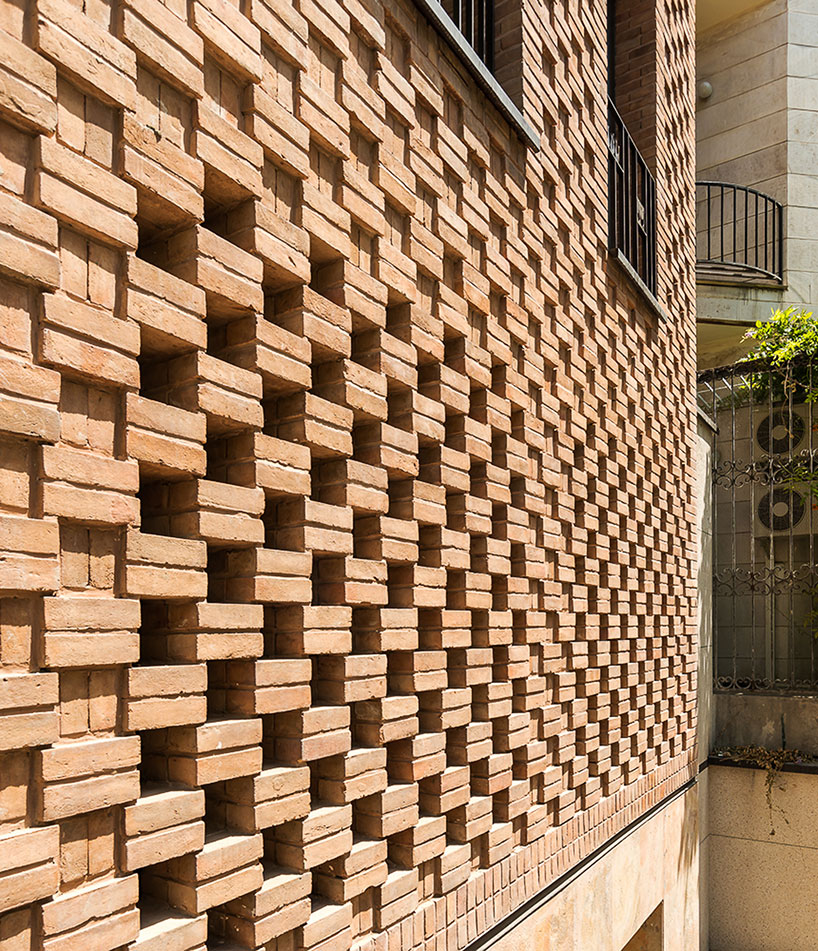 boozhgan architecture studio sculpts a dynamic brick facade for the haghighi house