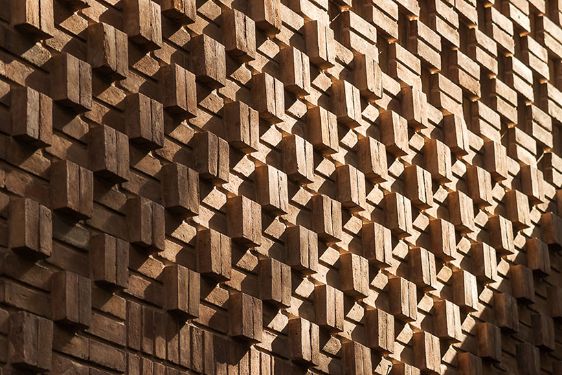 boozhgan architecture studio sculpts a dynamic brick facade for the haghighi house