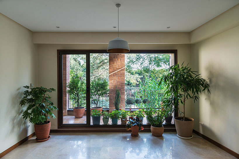 boozhgan architecture studio sculpts a dynamic brick facade for the haghighi house