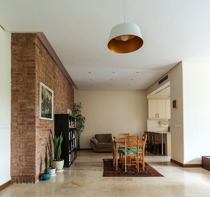 boozhgan architecture studio sculpts a dynamic brick facade for the haghighi house