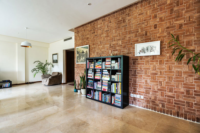 boozhgan architecture studio sculpts a dynamic brick facade for the haghighi house