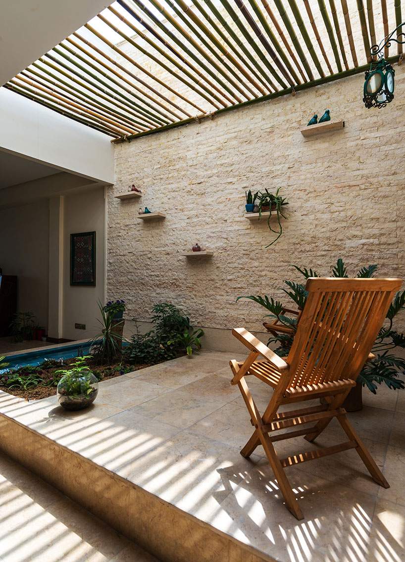 boozhgan architecture studio sculpts a dynamic brick facade for the haghighi house