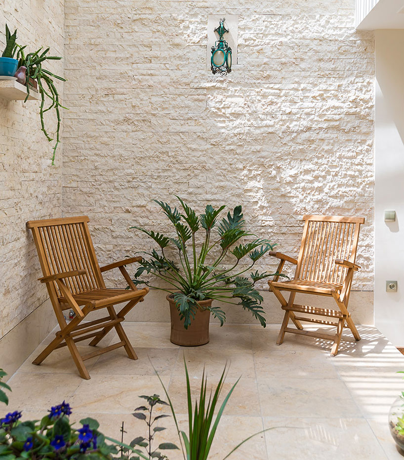 boozhgan architecture studio sculpts a dynamic brick facade for the haghighi house