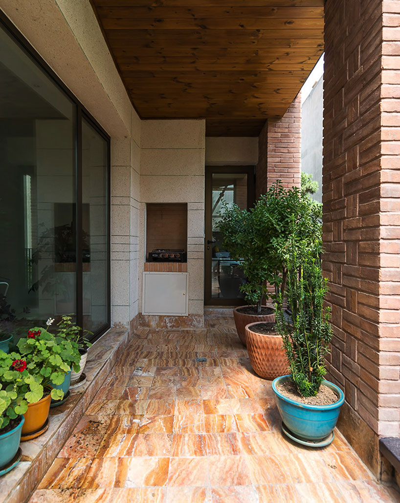 boozhgan architecture studio sculpts a dynamic brick facade for the haghighi house