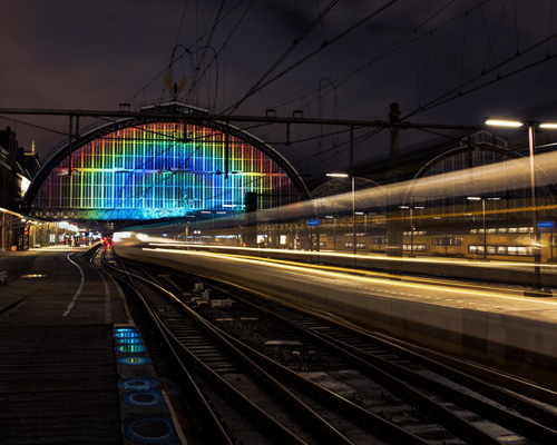 daan roosegaarde unravels a rainbow of light at amsterdam central station
