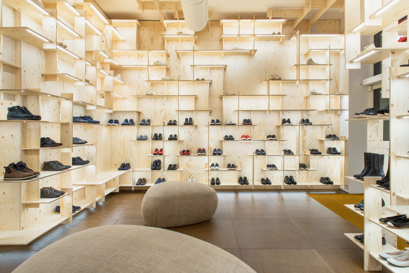 kengo kuma delineates milan camper store with gridded plywood shelves