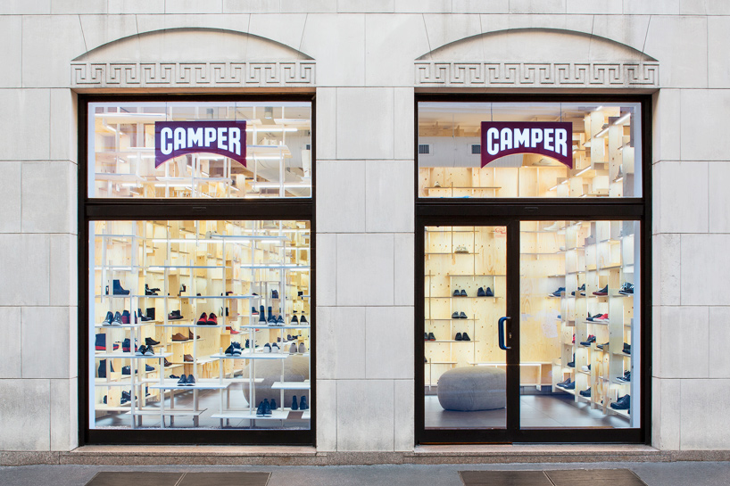 kengo kuma delineates milan camper store with gridded plywood shelves