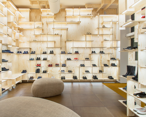 kengo kuma delineates milan camper store with gridded plywood shelves