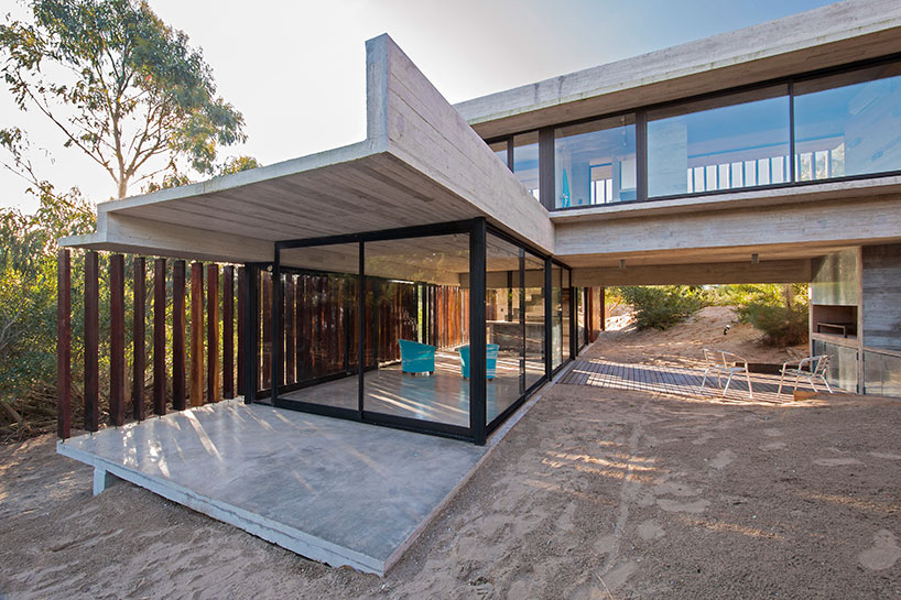 luciano kruk forms MR house of folded concrete and wooden louvers