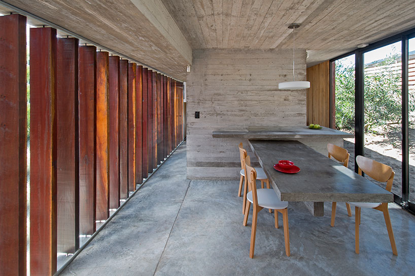 luciano kruk forms MR house of folded concrete and wooden louvers