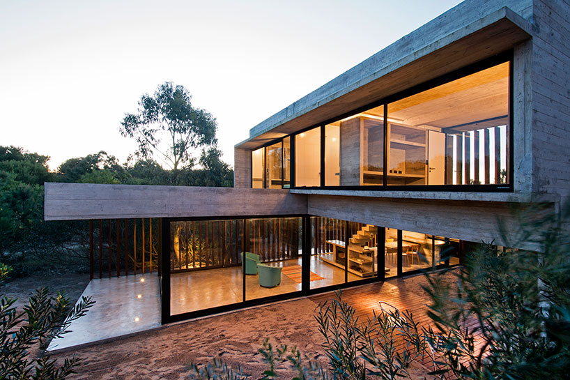 luciano kruk forms MR house of folded concrete and wooden louvers