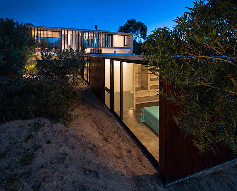 luciano kruk forms MR house of folded concrete and wooden louvers