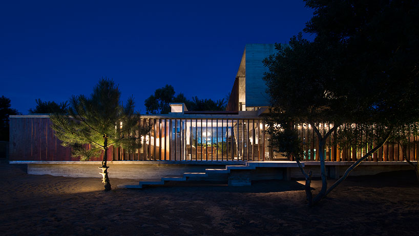 luciano kruk forms MR house of folded concrete and wooden louvers