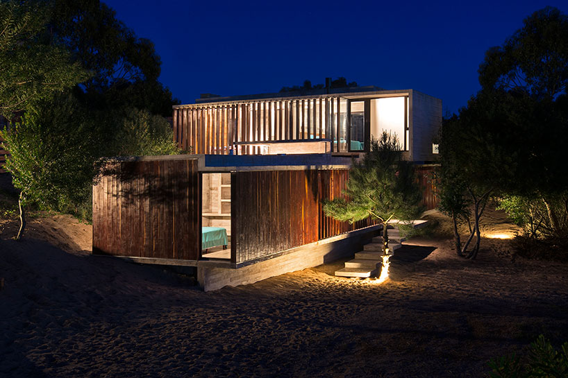 luciano kruk forms MR house of folded concrete and wooden louvers