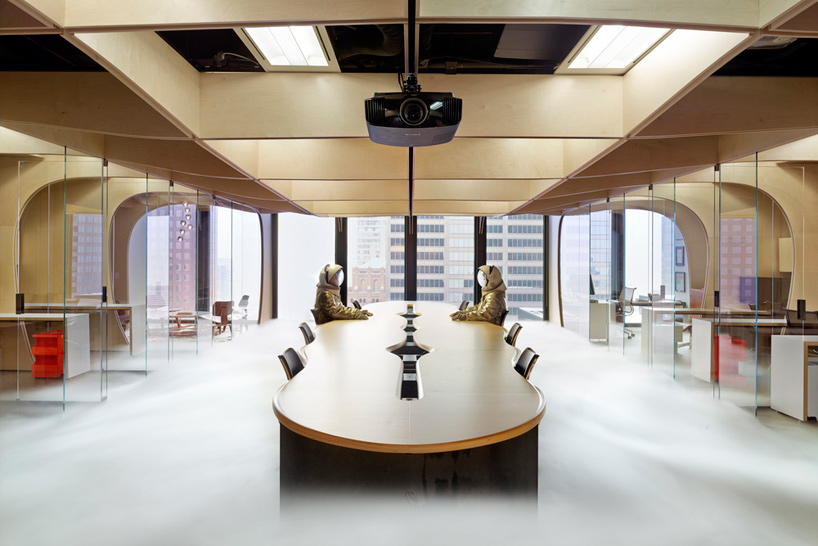 partisans delineates office space with a waffle of plywood surfaces