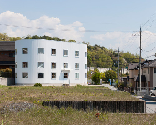 house in hikone by tato architects presents cylindrical façade of windows
