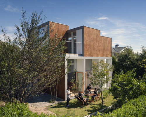 family home by masaki ihara is a composition of timber-clad volumes