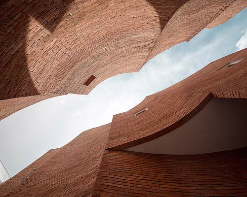 boutique hotel fuses multi-curved brick walls with pure white geometries