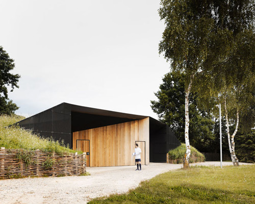 MU architecture's forge-les-bains locker rooms emerge from hillside